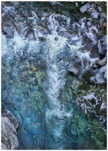 Swirling water forms fleeting images in the Yuba River